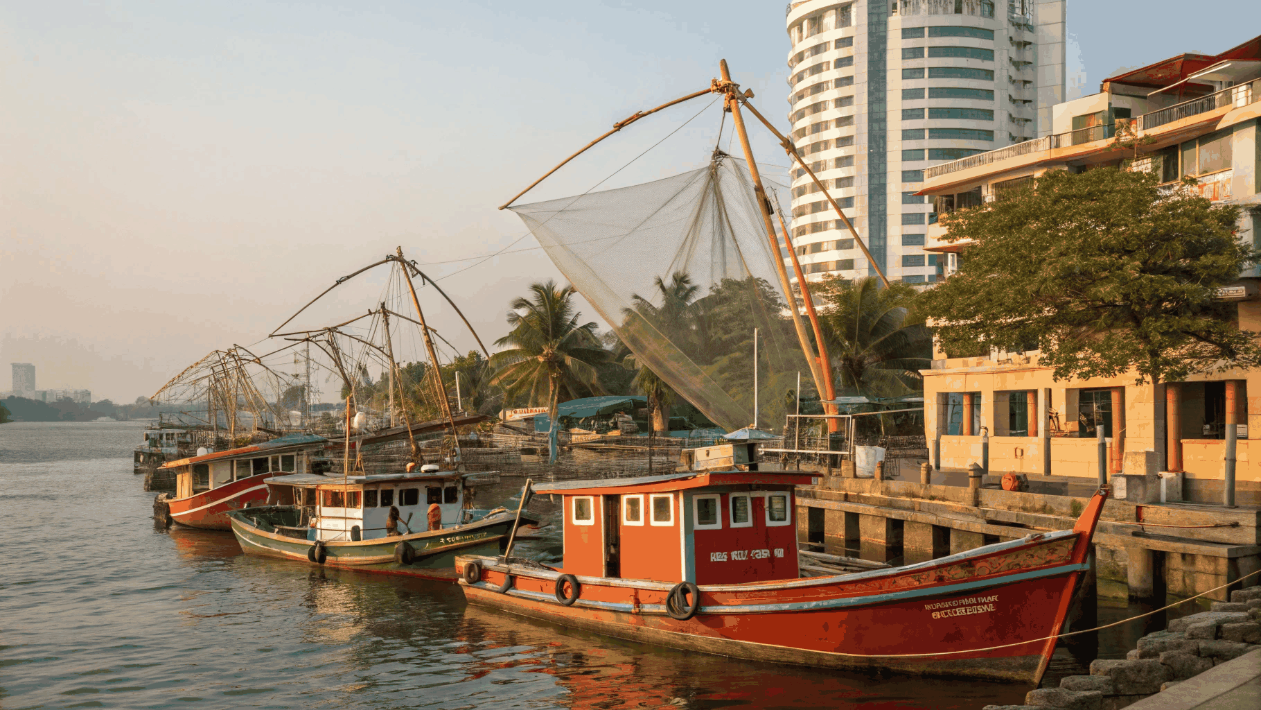 Historic Fort Kochi Chinese fishing nets along the coastline at sunset